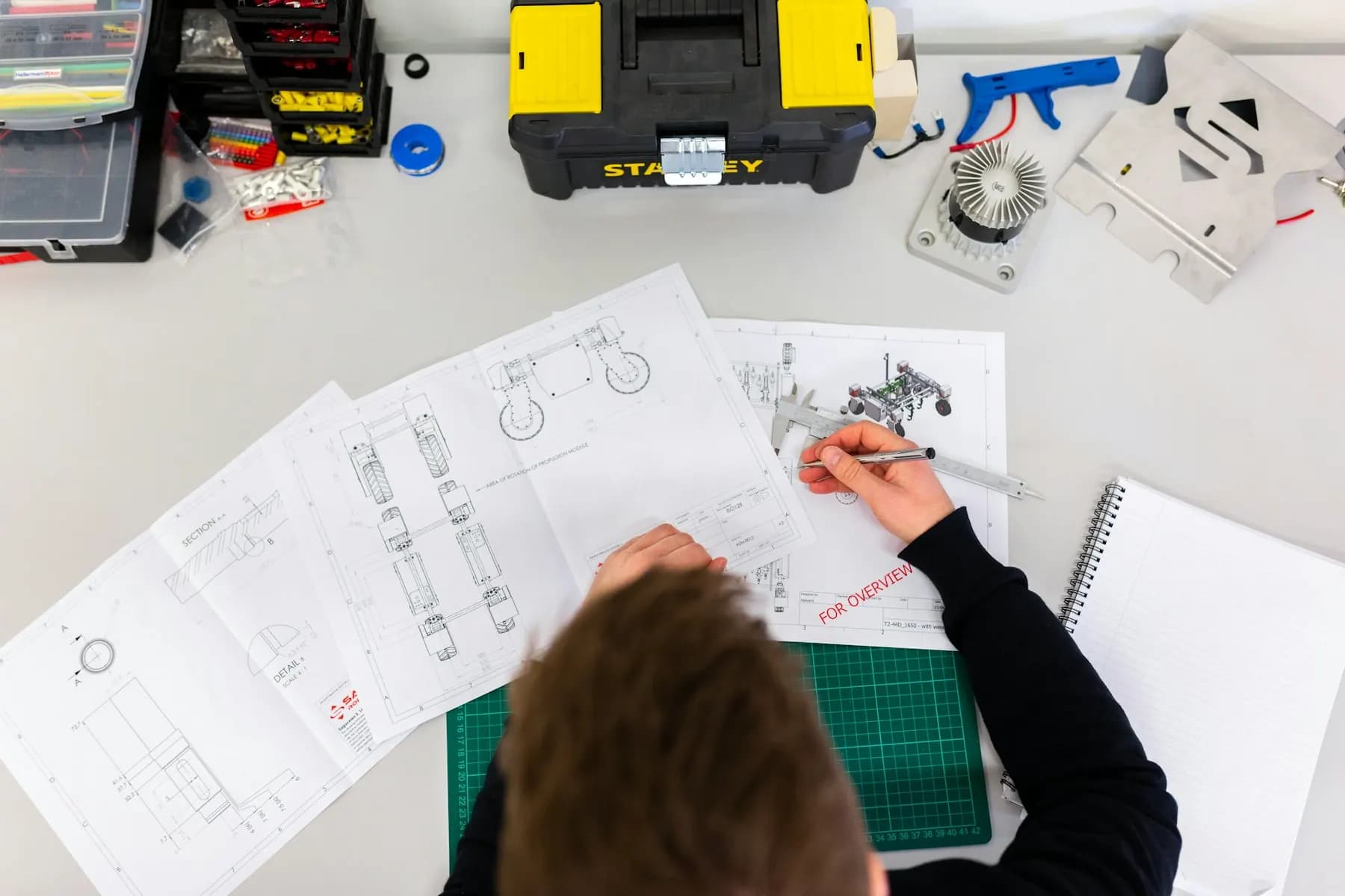 Engineers in hi-vis reviewing practical work on a training campus