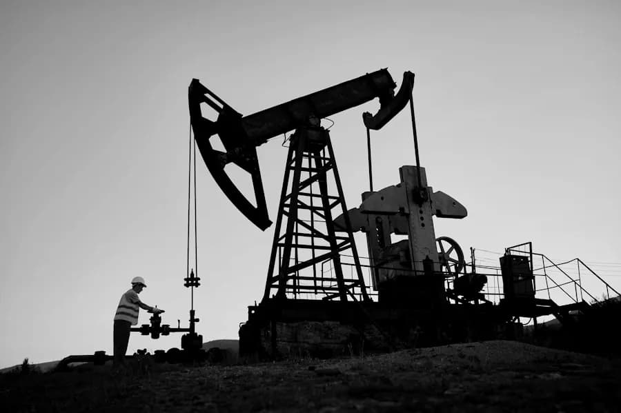 Engineer inspecting oil pump jack on site